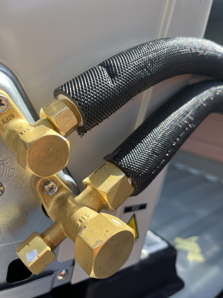 Black UV-rated insulated pair coil connected to air conditioner