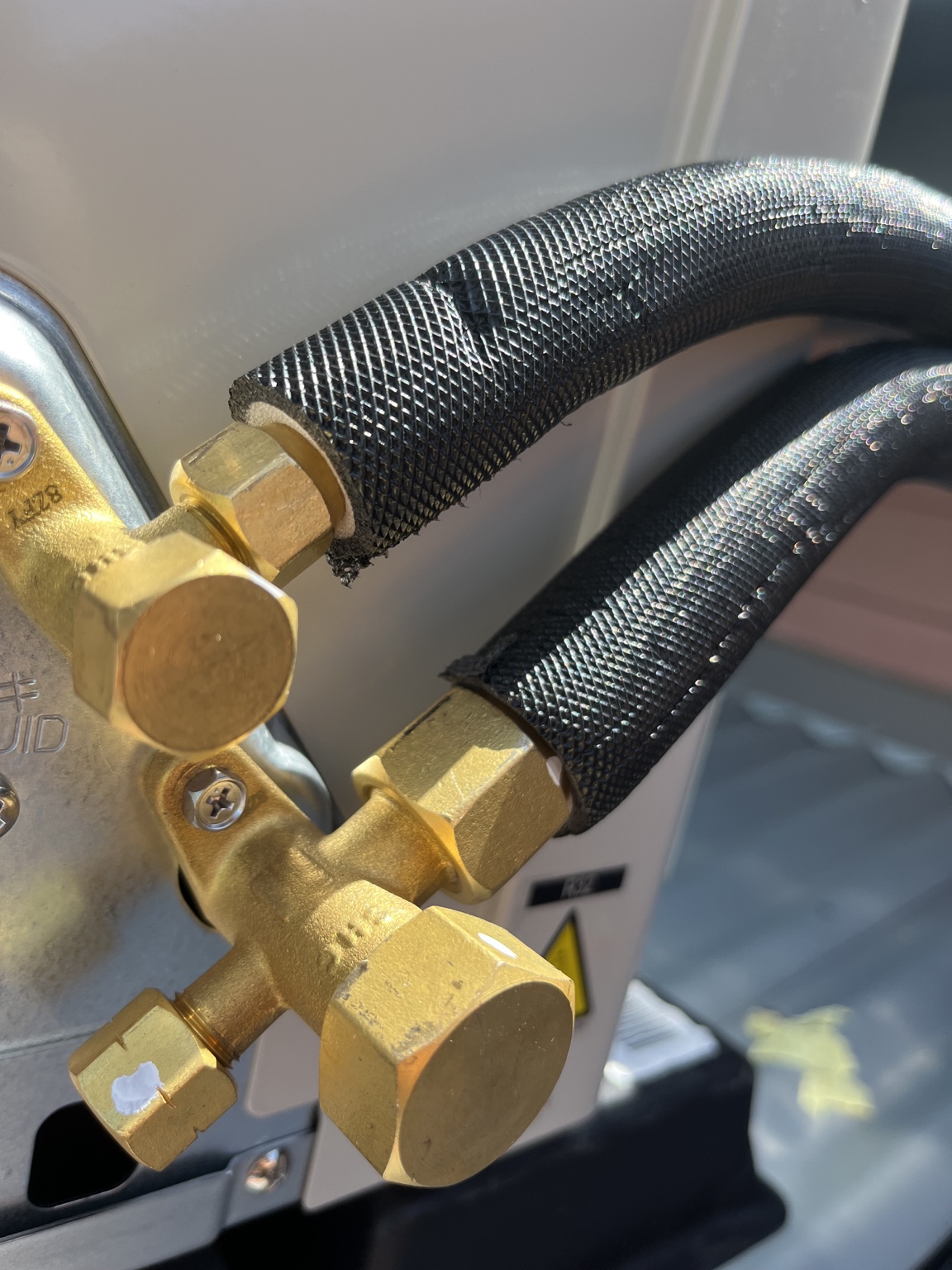 Black UV-rated insulated pair coil connected to air conditioner