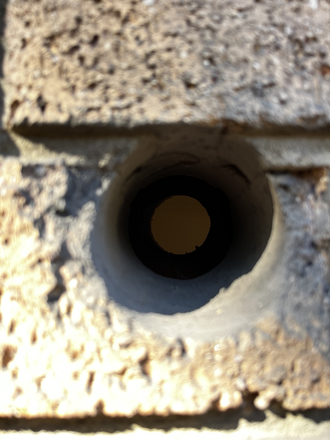 Clean core-drilled opening through a brick wall