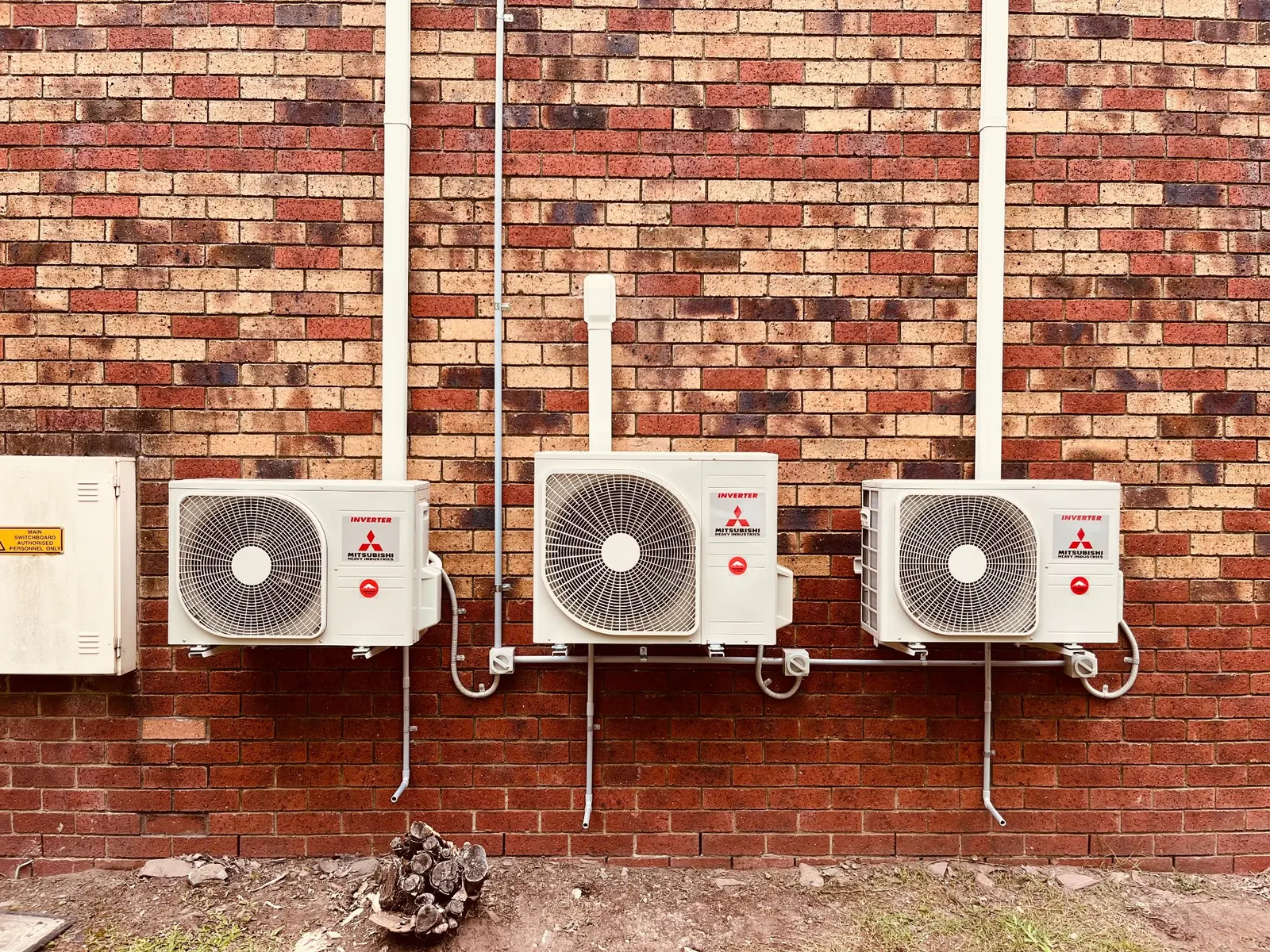 Three neatly installed Mitsubishi Heavy Industries outdoor units